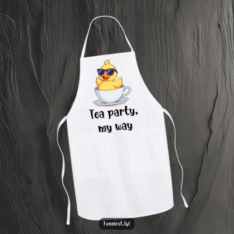 Funny apron showing a rubber duck wearing sunglasses, floating upside down in a teacup, adding humorous charm to kitchen activities.